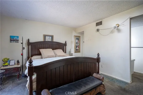 a bedroom with a bed and a chair