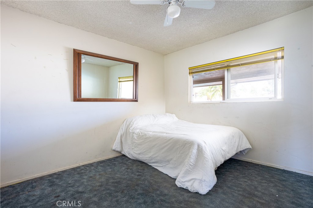 5669 Magnolia Avenue Rialto, CA 92377 - Photo 21 of 35 a bed sitting in a bedroom next to a window