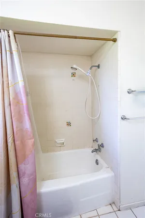 a bath tub sitting next to a white sink and vanity