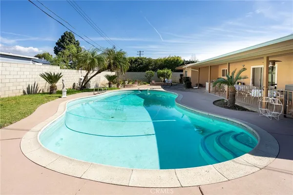 a view of a swimming pool with an outdoor seating