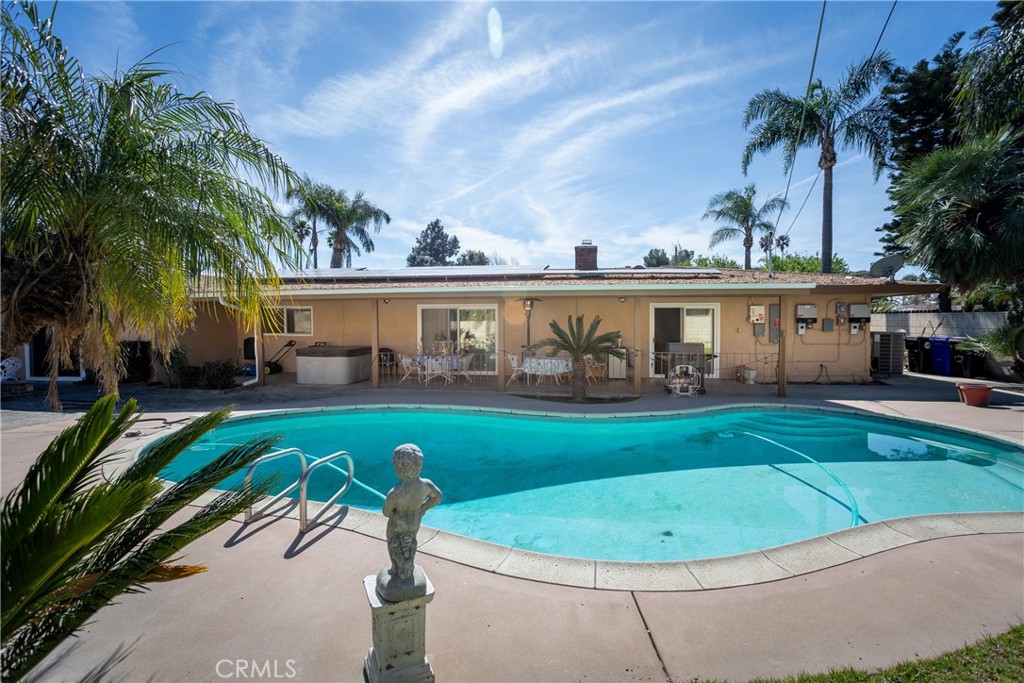 5669 Magnolia Avenue Rialto, CA 92377 - Photo 27 of 35 a view of a swimming pool with a garden and plants