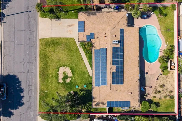 an aerial view of a house with a swimming pool