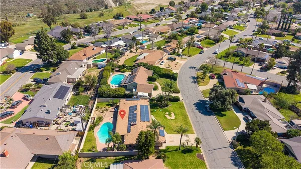 an aerial view of residential houses with outdoor space and swimming pool