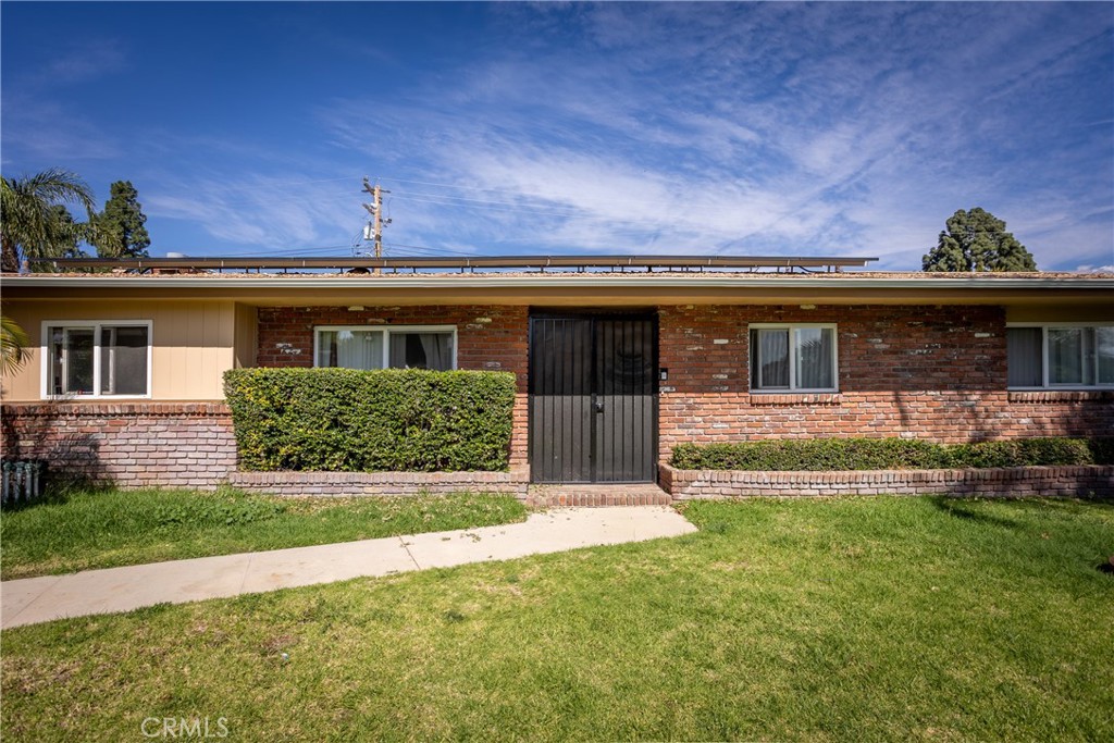 5669 Magnolia Avenue Rialto, CA 92377 - Photo 3 of 35 front view of a house with a yard