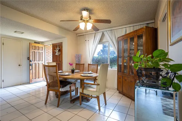 a view of a dining room with furniture and a potted plant