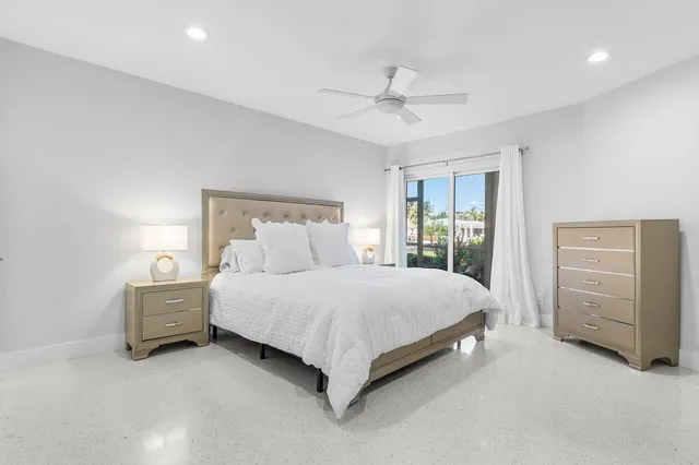 a spacious bedroom with a bed and a cabinets