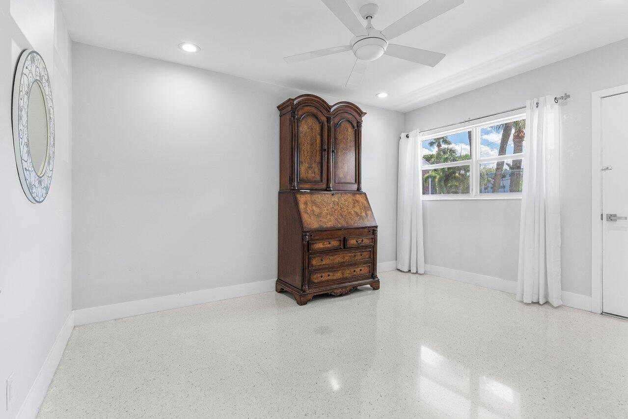 701 Harbour Drive, Unit 103 Boca Raton, FL 33431 - Photo 17 of 39 an empty room with windows and ceiling fan