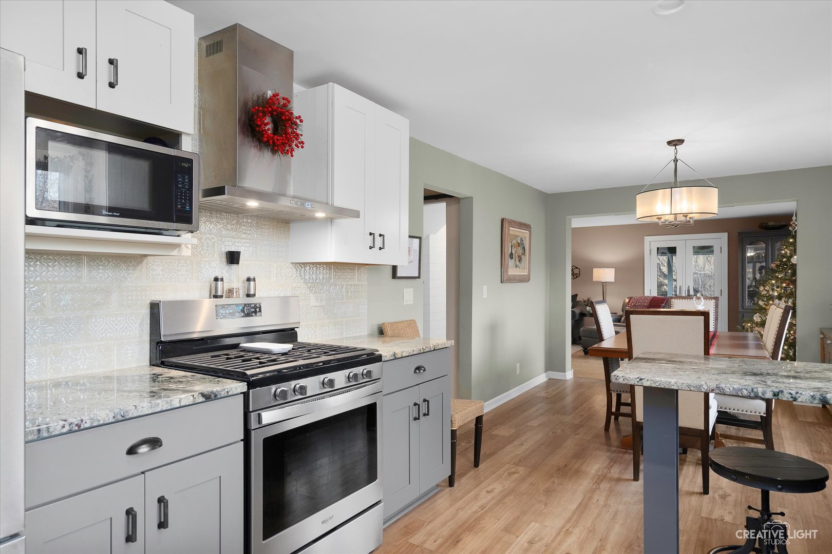 991 Hillcrest Road Elgin, IL 60123 - Photo 13 of 35 a kitchen with stainless steel appliances kitchen island granite countertop a stove a sink and a microwave