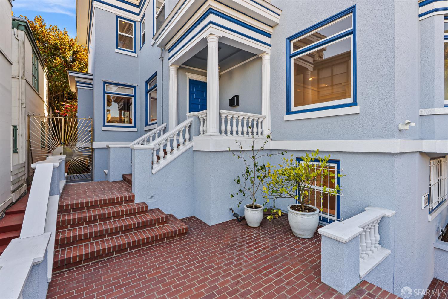 a view of a patio with couches table and chairs and potted plants