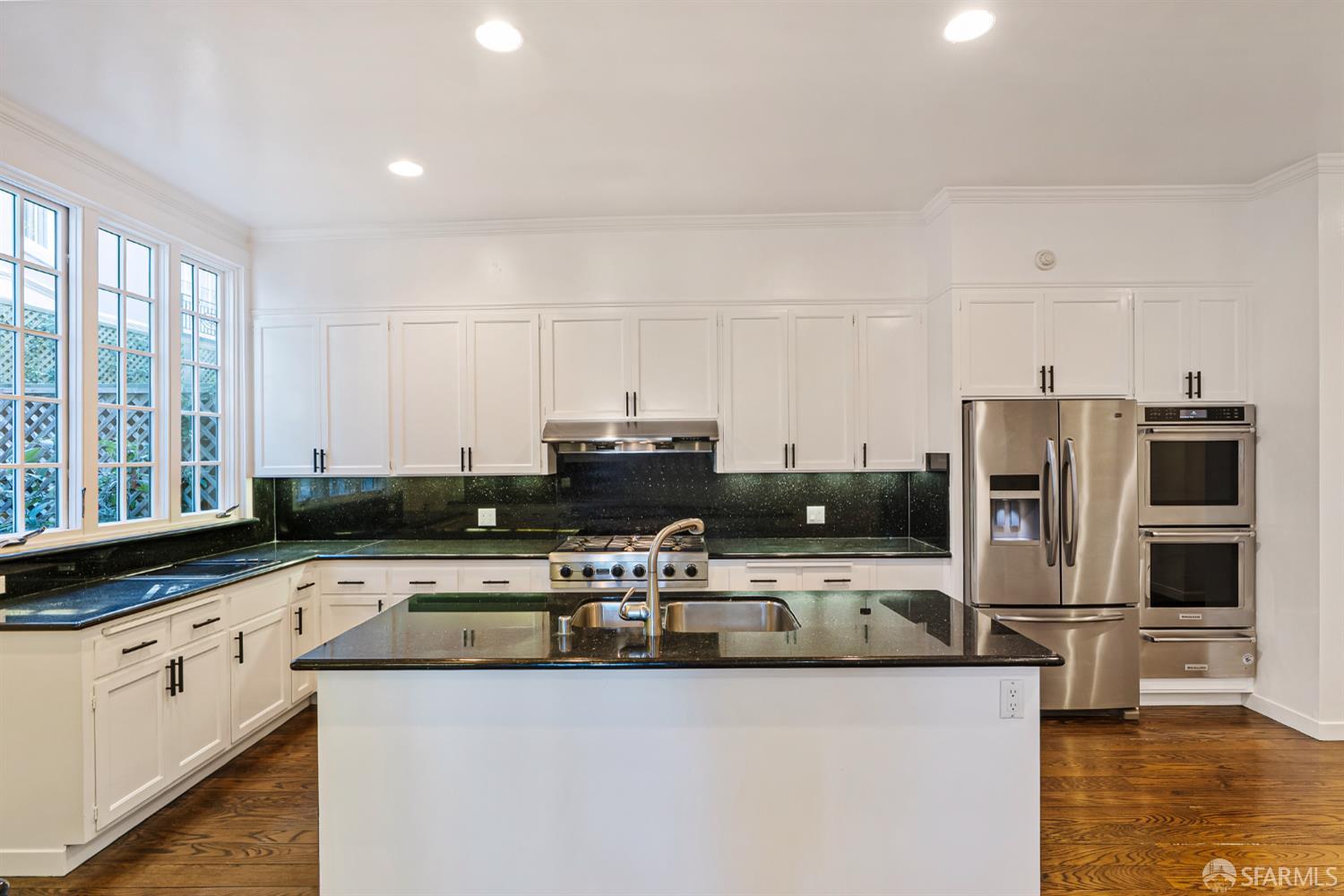 2521 Broadway San Francisco, CA 94115 - Photo 14 of 74 a kitchen with stainless steel appliances a stove a sink a microwave and cabinets