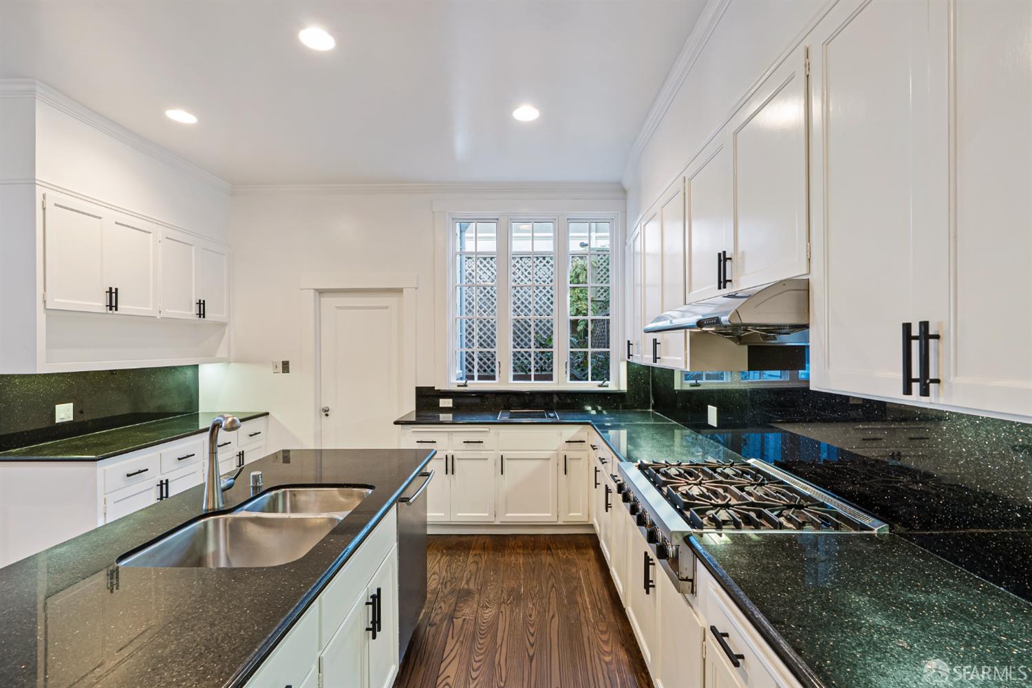 2521 Broadway San Francisco, CA 94115 - Photo 15 of 74 a kitchen with a stove a sink and a granite counter tops