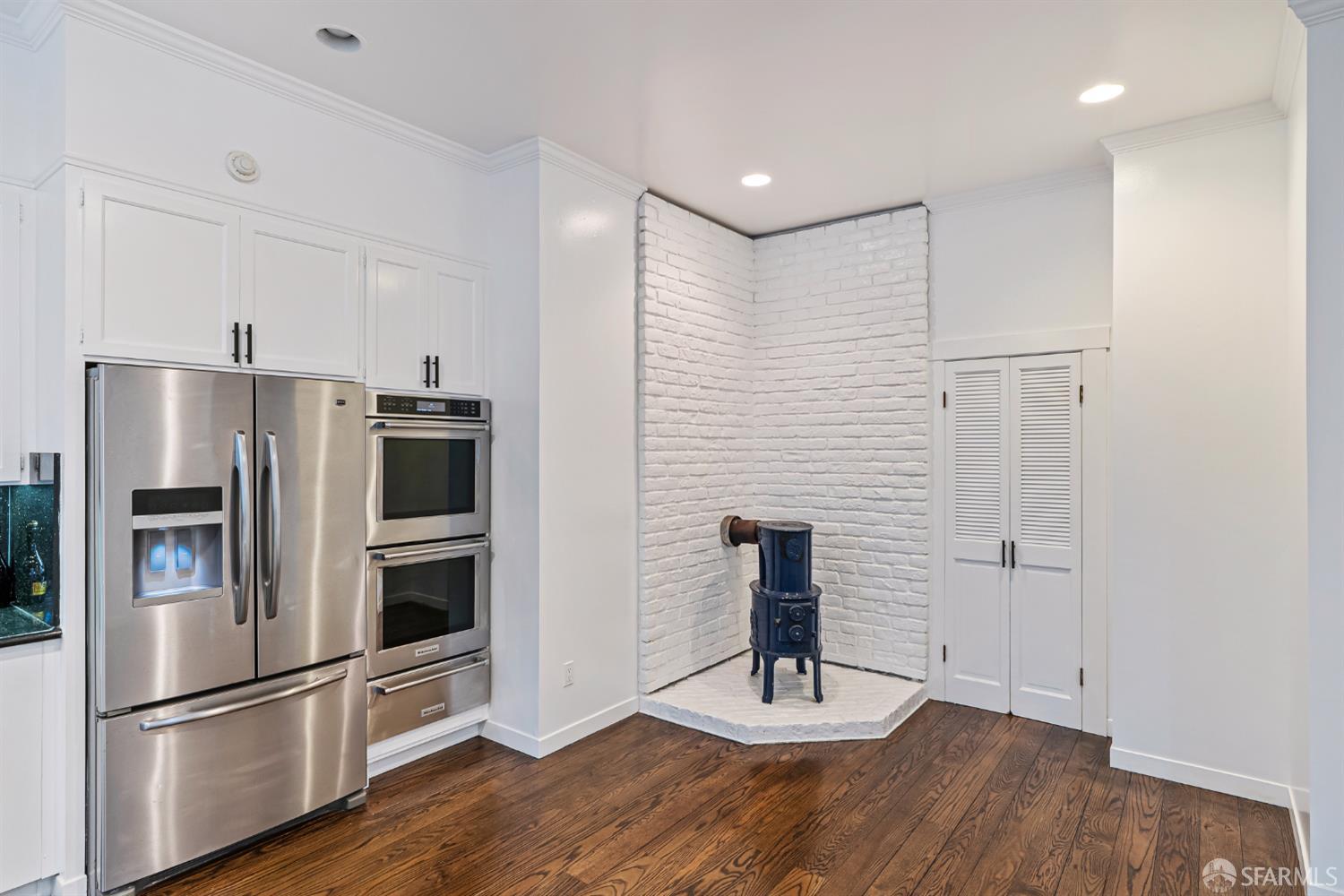 2521 Broadway San Francisco, CA 94115 - Photo 18 of 74 a kitchen with stainless steel appliances a refrigerator and wooden floor
