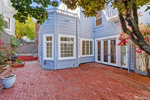 a view of a big room with wooden floor and windows