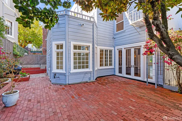 a view of a big room with wooden floor and windows
