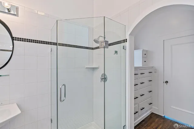 a view of a room with wooden floors and cabinet