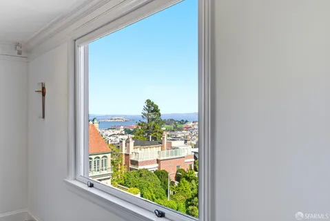 a front view of a house with yard and parking
