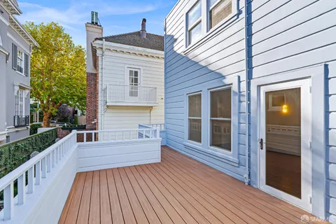 an empty room with fireplace and fan