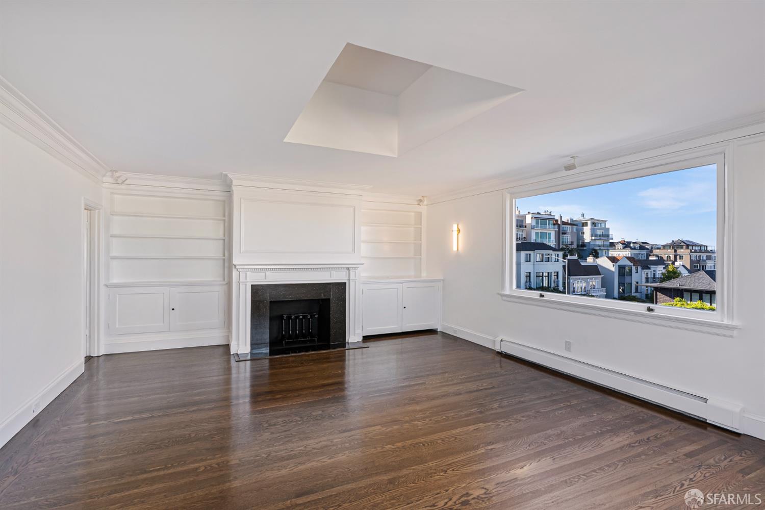 2521 Broadway San Francisco, CA 94115 - Photo 42 of 74 an empty room with wooden floor fireplace and windows