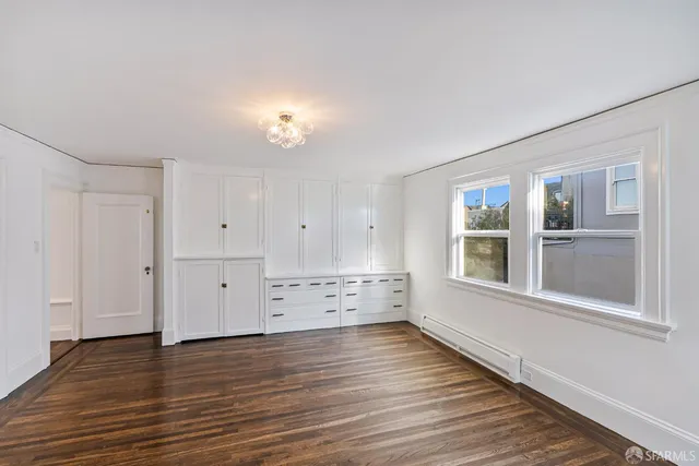 a view of walk in closet with empty racks