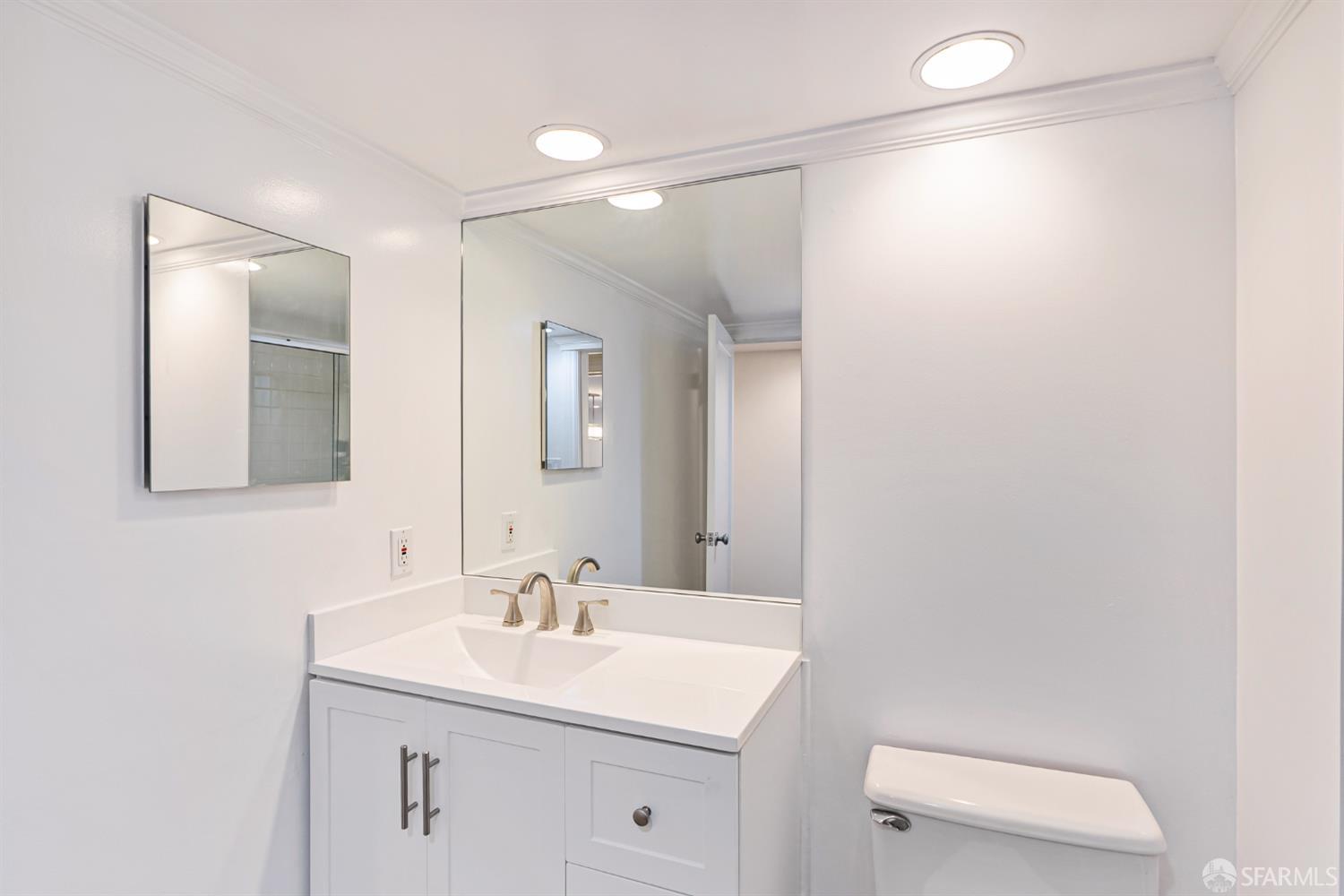 2521 Broadway San Francisco, CA 94115 - Photo 51 of 74 a bathroom with a sink a toilet and mirror