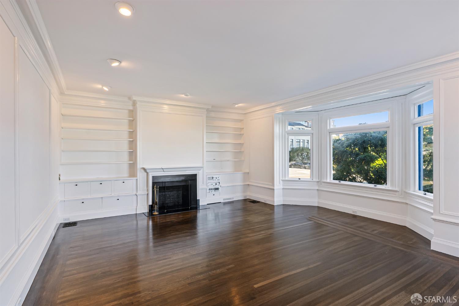 2521 Broadway San Francisco, CA 94115 - Photo 8 of 74 an empty room with wooden floor fireplace and windows