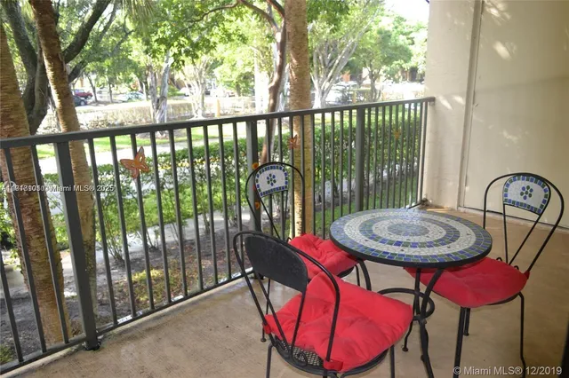 a view of a balcony with a table and chairs