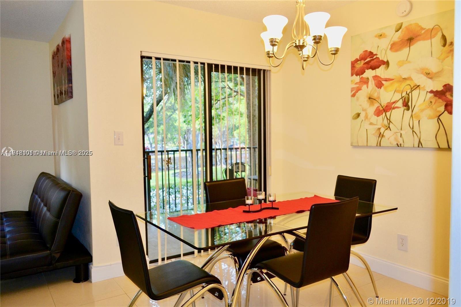 620 South Park Road, Unit 272 Hollywood, FL 33021 - Photo 5 of 23 a view of a dining room with furniture and chandelier