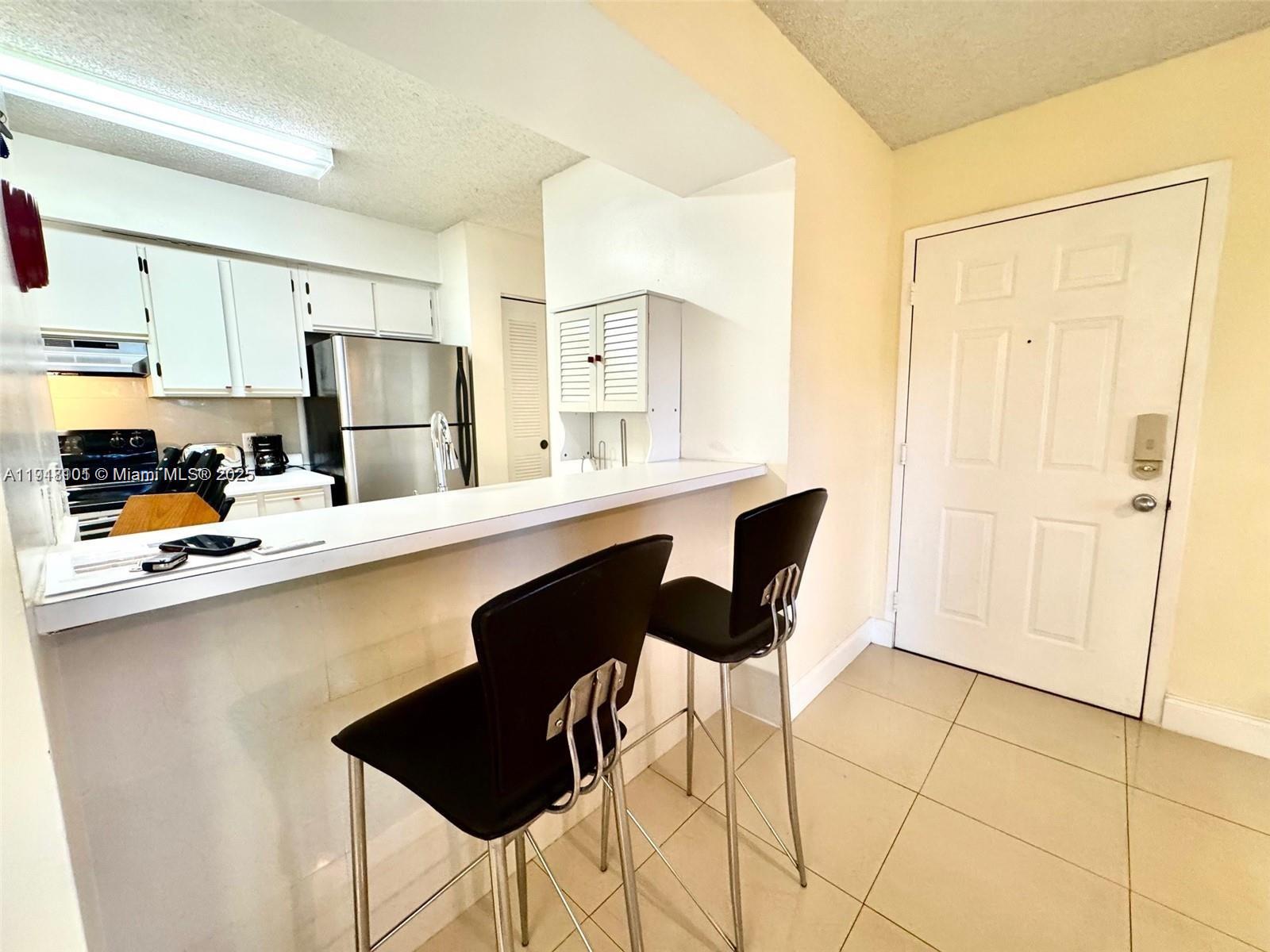 620 South Park Road, Unit 272 Hollywood, FL 33021 - Photo 9 of 23 a kitchen with stainless steel appliances a sink and a refrigerator