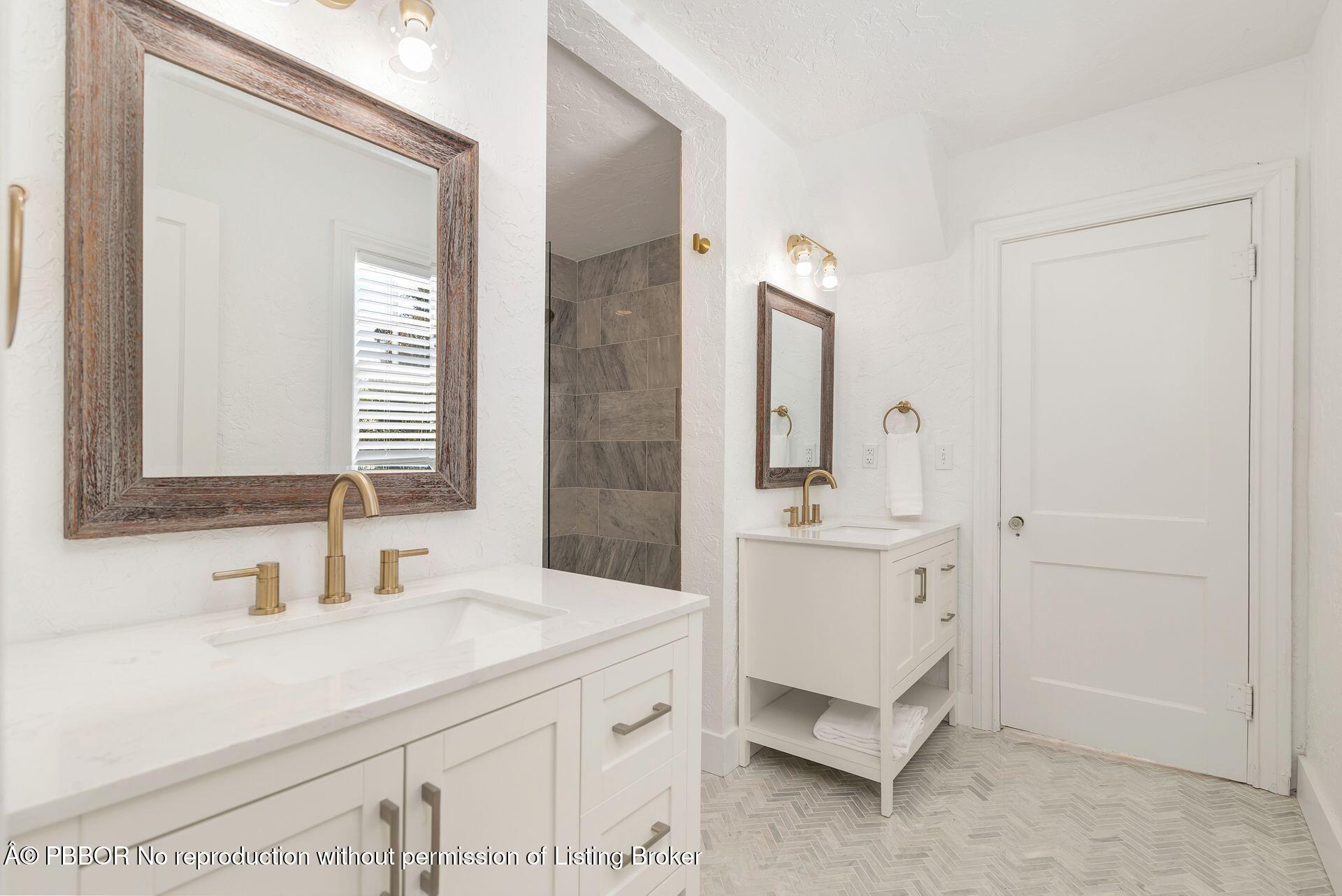 3020 Vincent Road West Palm Beach, FL 33405 - Photo 16 of 56 a bathroom with a sink a mirror and a bathtub