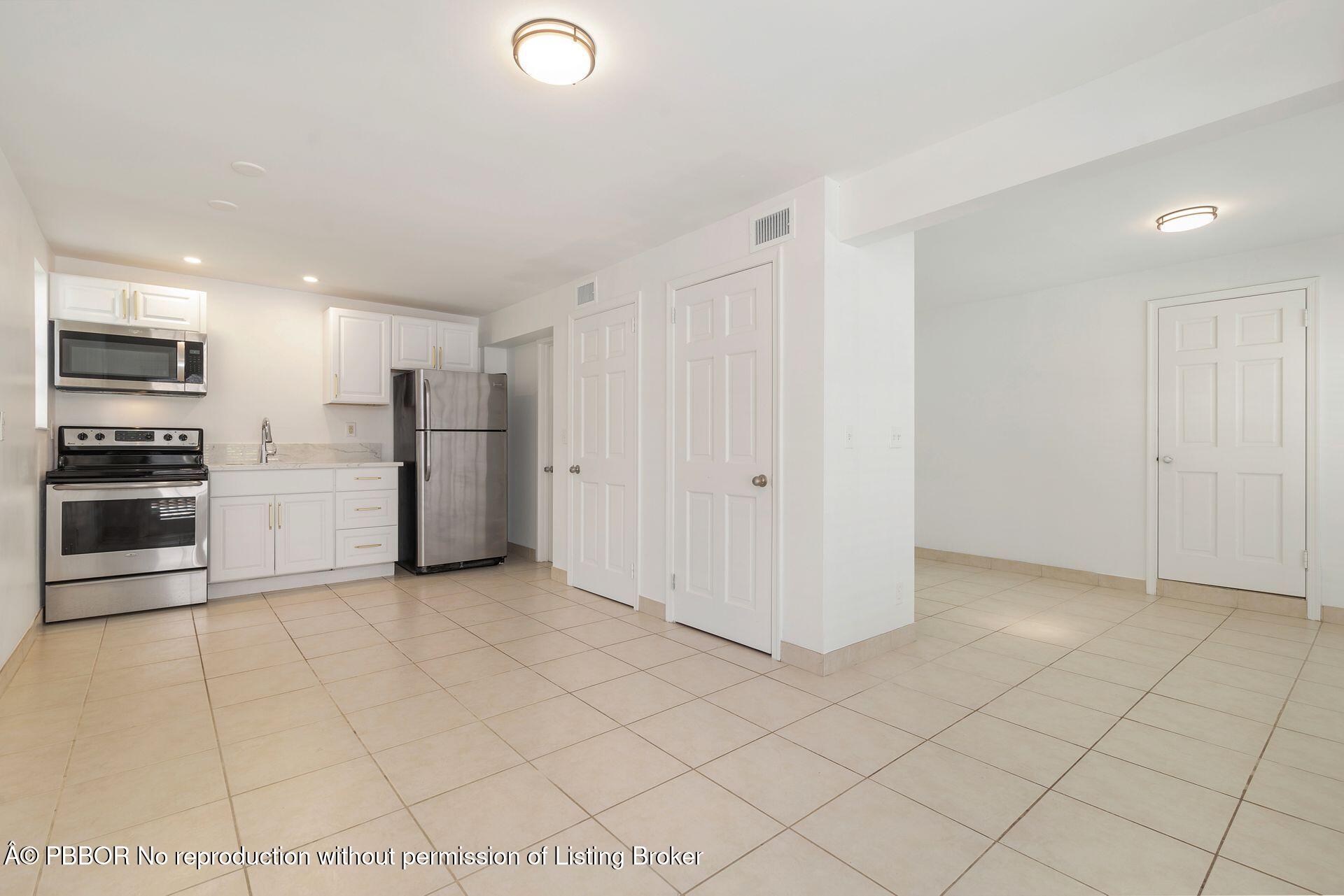 3020 Vincent Road West Palm Beach, FL 33405 - Photo 24 of 56 a view of a kitchen with a sink and an oven