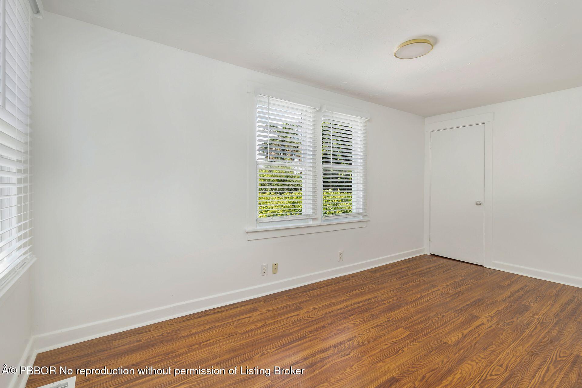 3020 Vincent Road West Palm Beach, FL 33405 - Photo 33 of 56 an empty room with wooden floor and windows