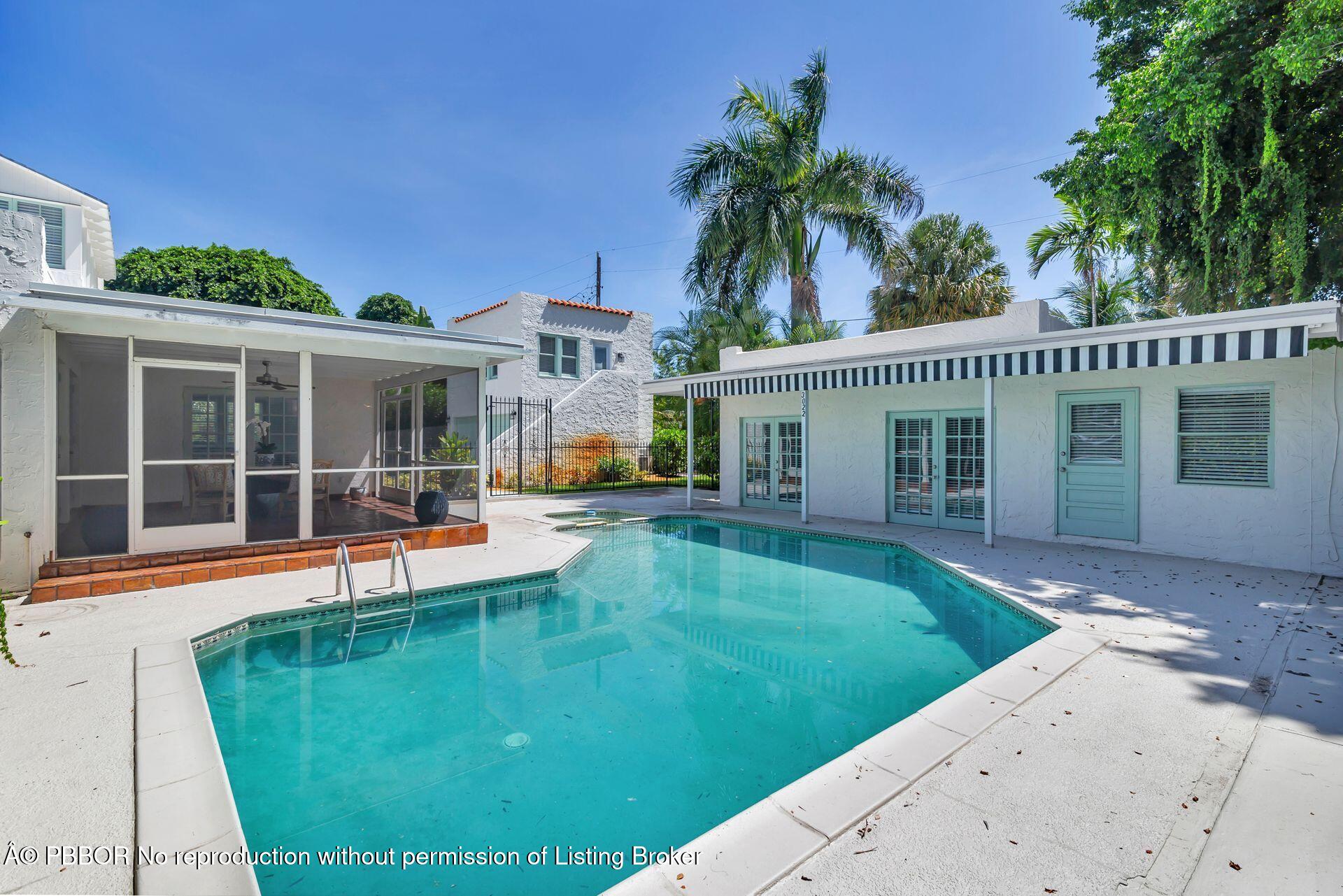 3020 Vincent Road West Palm Beach, FL 33405 - Photo 40 of 56 a view of a house with a swimming pool and a yard