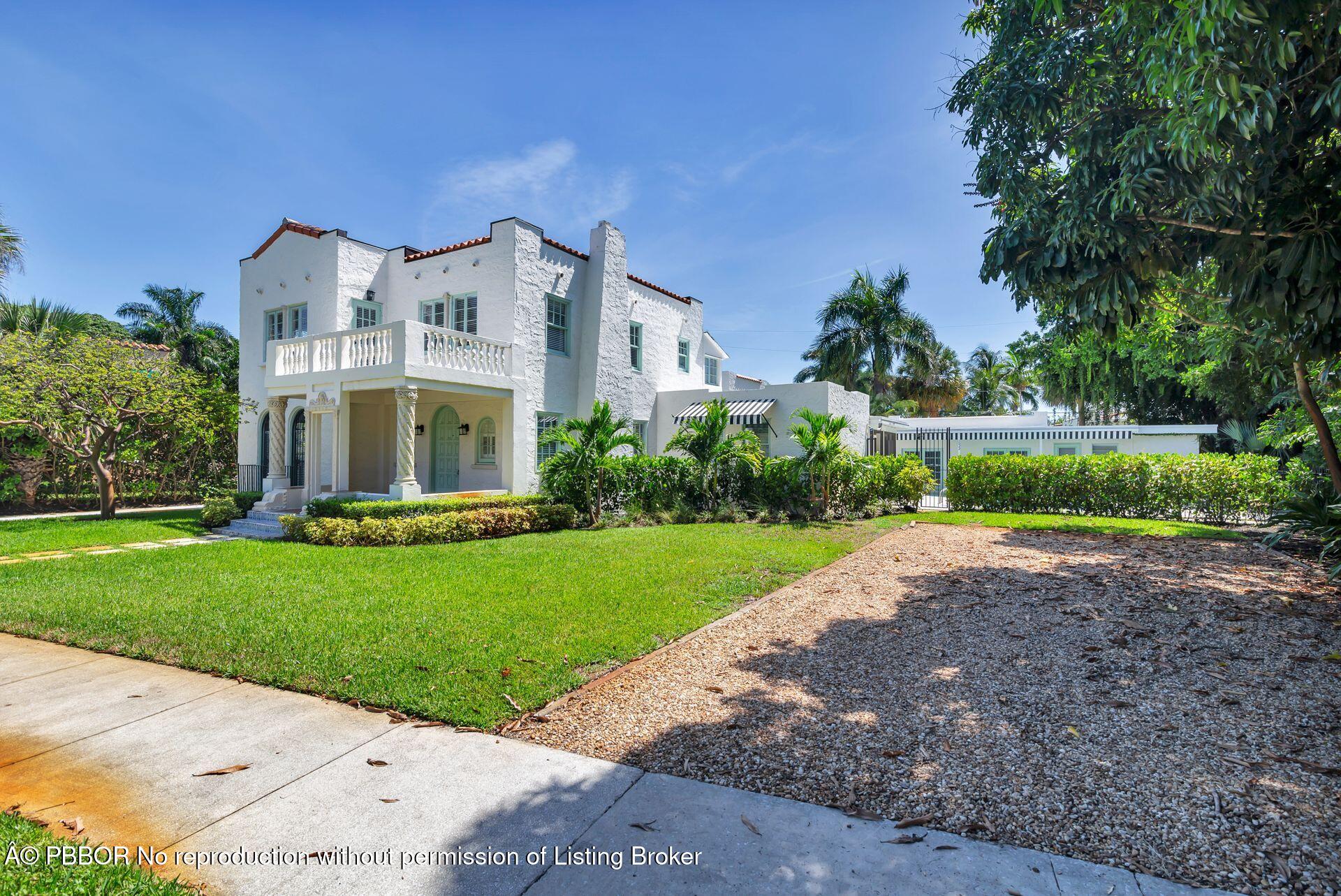 3020 Vincent Road West Palm Beach, FL 33405 - Photo 54 of 56 a front view of a house with a yard and garage