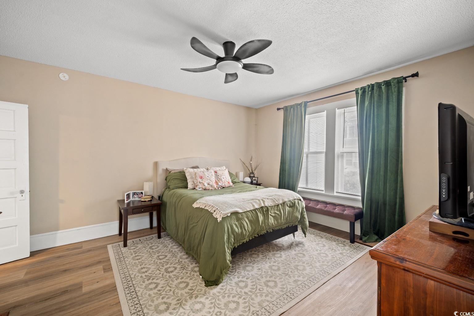 222 East Wine Street Mullins, SC 29574 - Photo 25 of 40 Bedroom with light wood finished floors, a textured ceiling, and a ceiling fan
