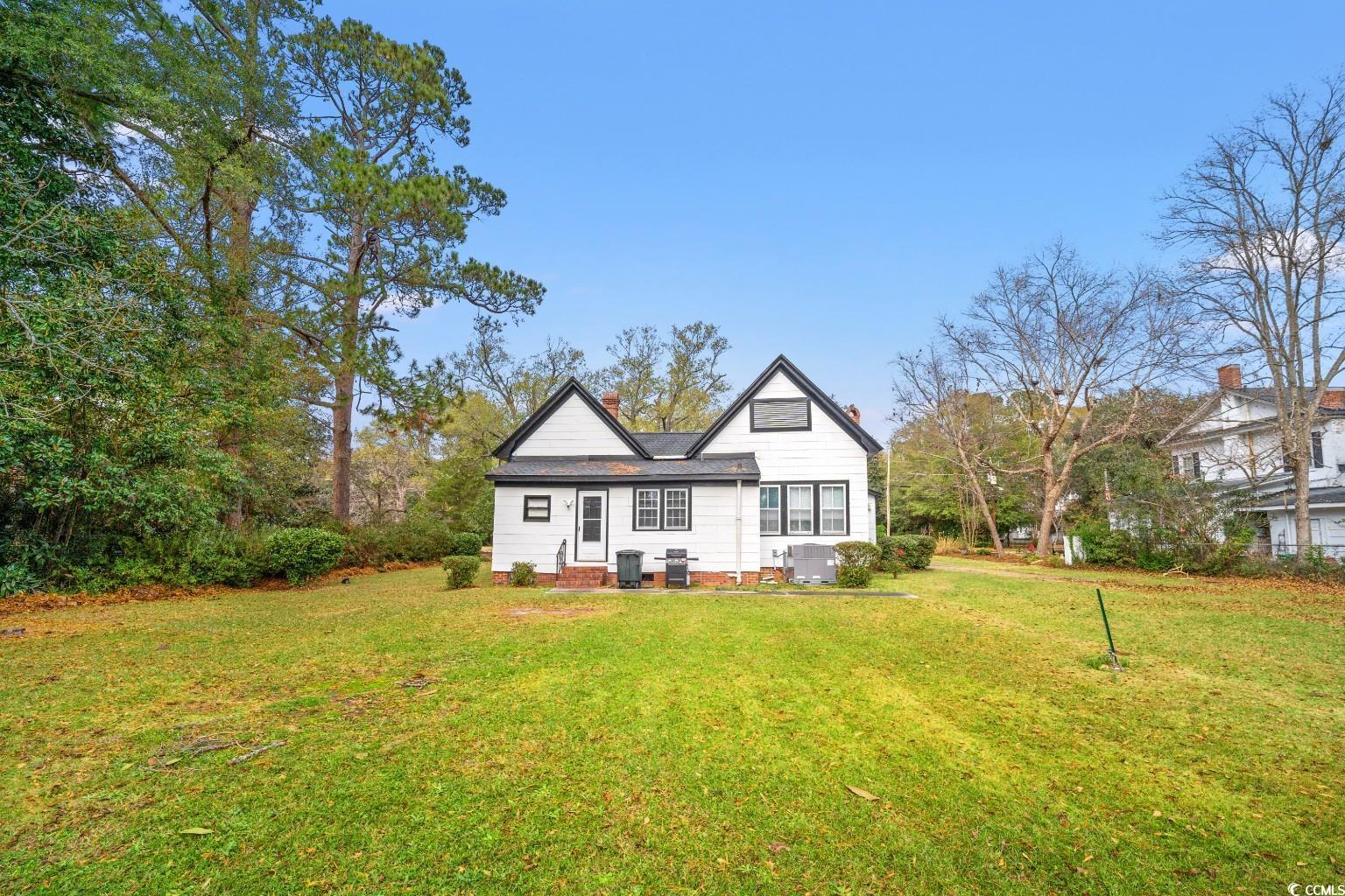 222 East Wine Street Mullins, SC 29574 - Photo 32 of 40 Rear view of house with a yard