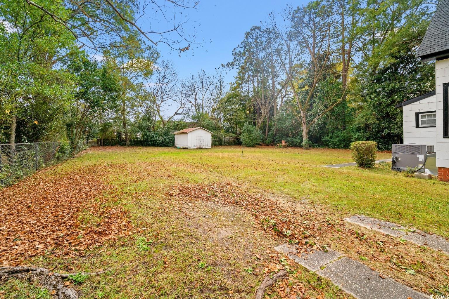 222 East Wine Street Mullins, SC 29574 - Photo 35 of 40 Fenced backyard featuring a storage unit