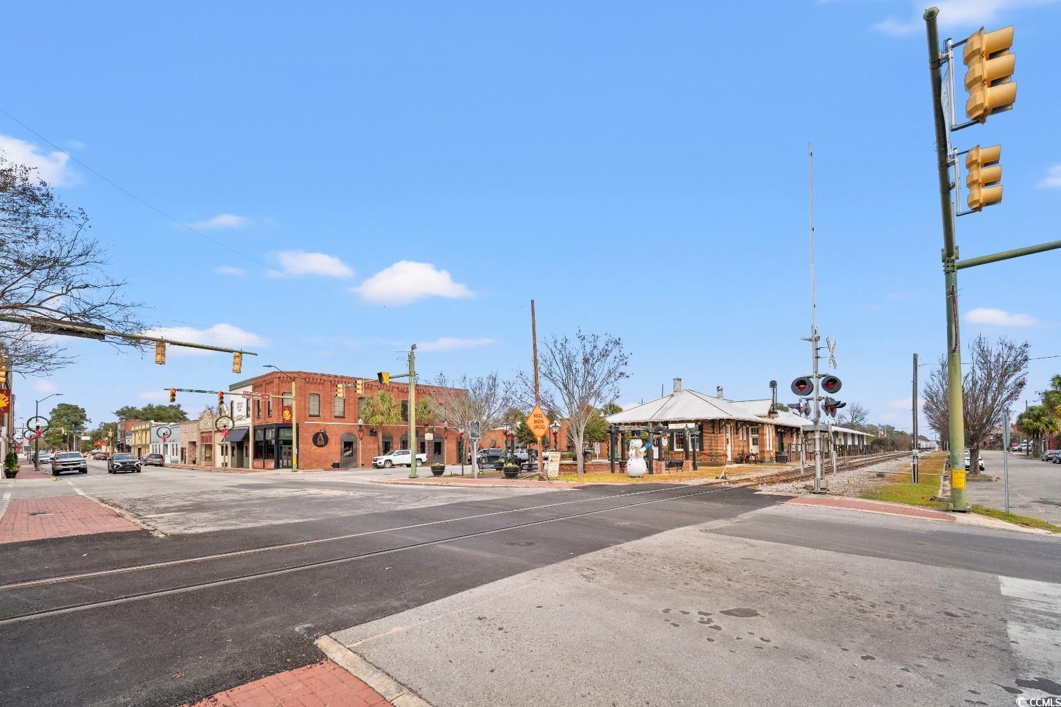 222 East Wine Street Mullins, SC 29574 - Photo 39 of 40 View of asphalt street with traffic lights, sidewalks, curbs, traffic signs, and street lights
