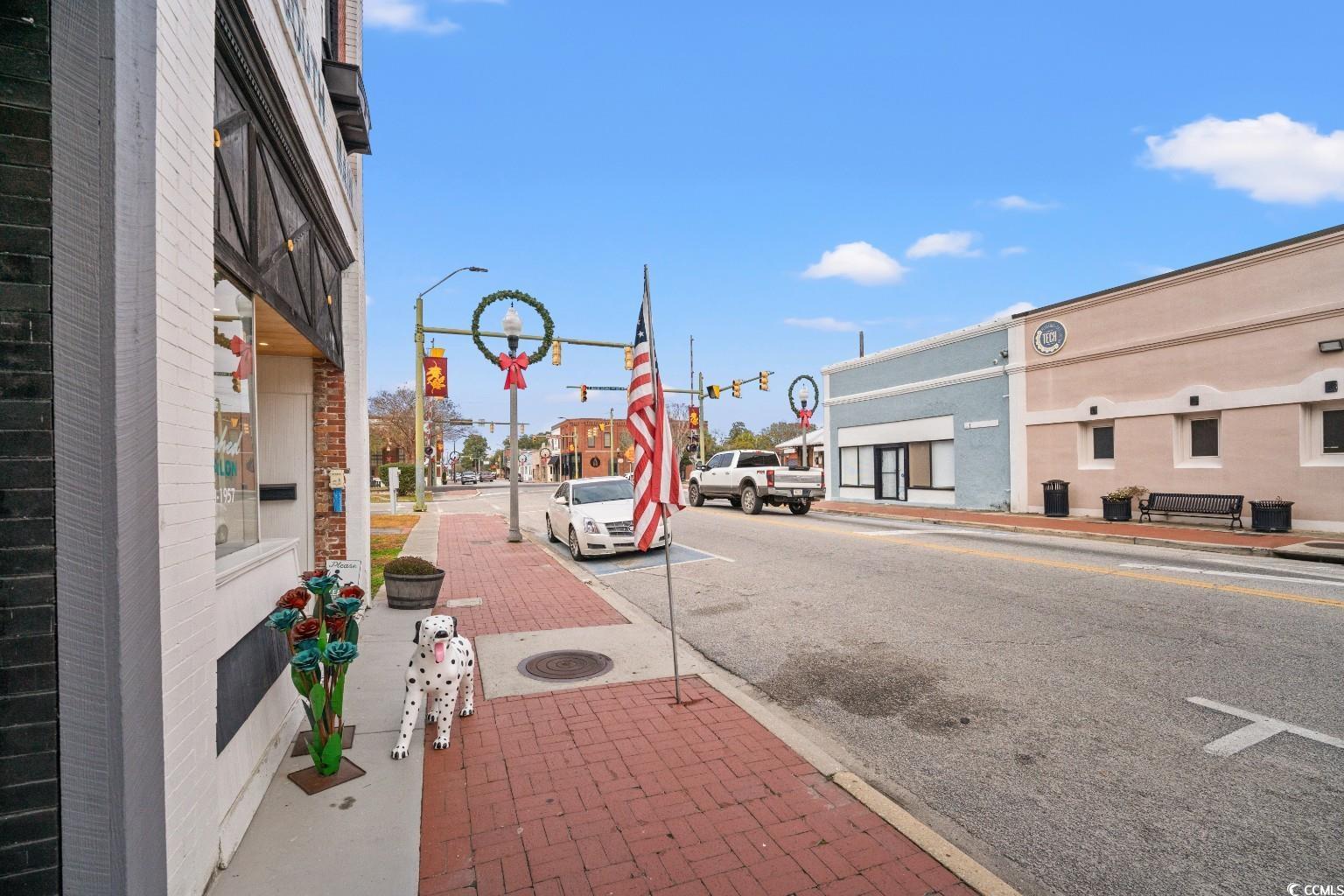 222 East Wine Street Mullins, SC 29574 - Photo 40 of 40 View of asphalt road with sidewalks, curbs, traffic lights, and street lighting