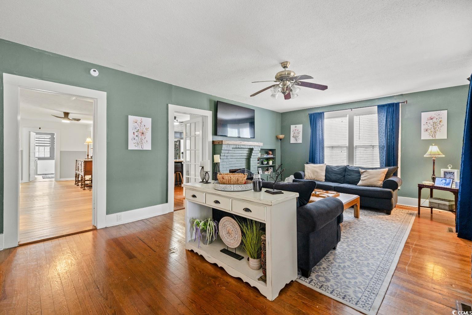 222 East Wine Street Mullins, SC 29574 - Photo 7 of 40 Living area with a ceiling fan and hardwood / wood-style flooring
