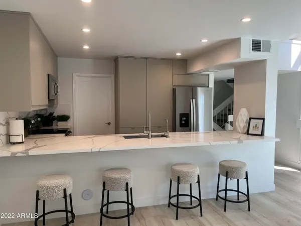 a kitchen with stainless steel appliances a sink and a refrigerator