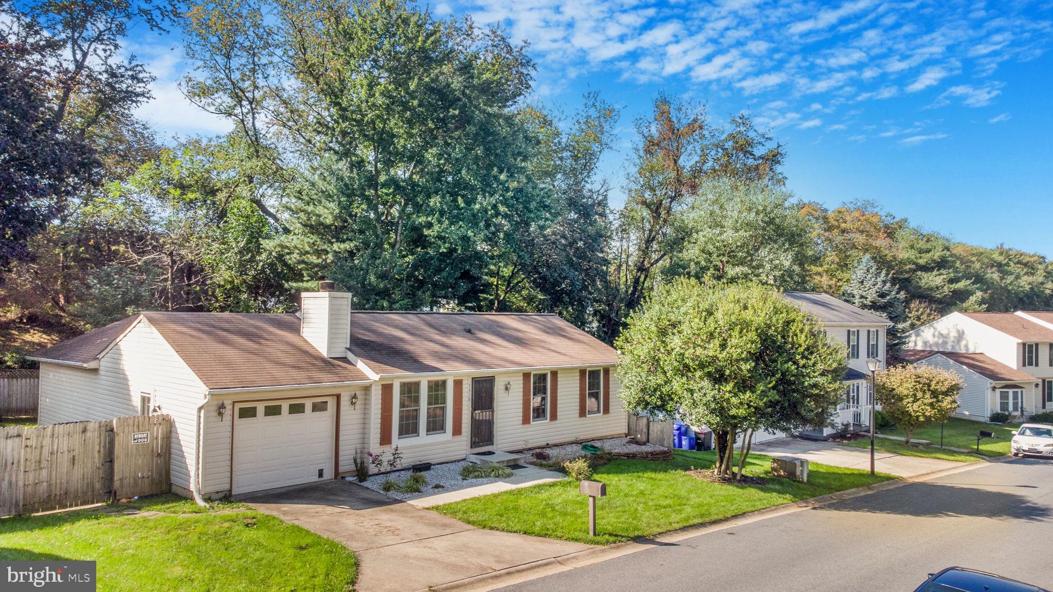 7316 Torran Rocks Way Gaithersburg, MD 20879 - Photo 3 of 17 a view of a big house with a big yard plants and large trees