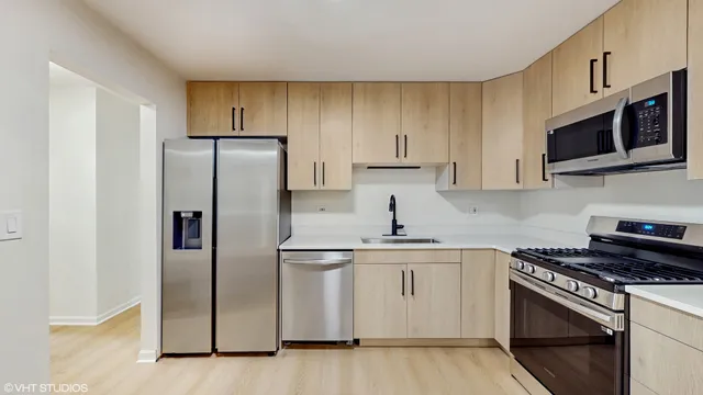 a kitchen with stainless steel appliances a refrigerator stove and microwave