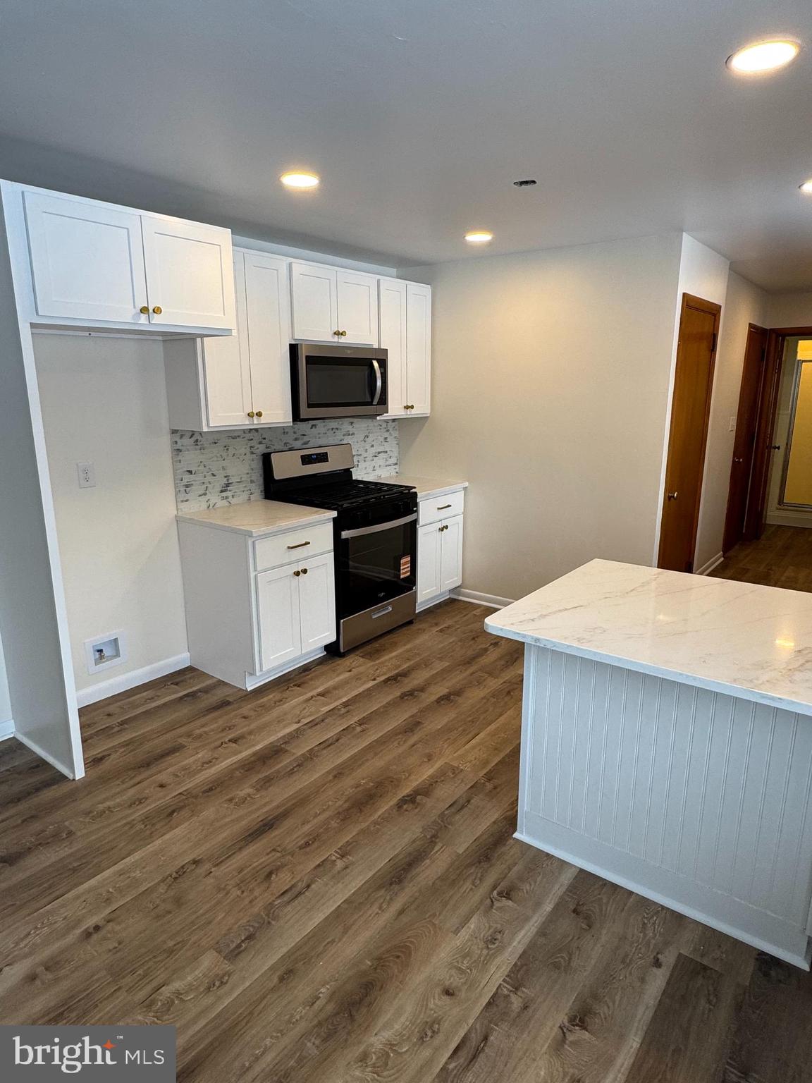3510 Carlisle Road Dover, PA 17315 - Photo 4 of 32 a kitchen with wooden floors and white appliances