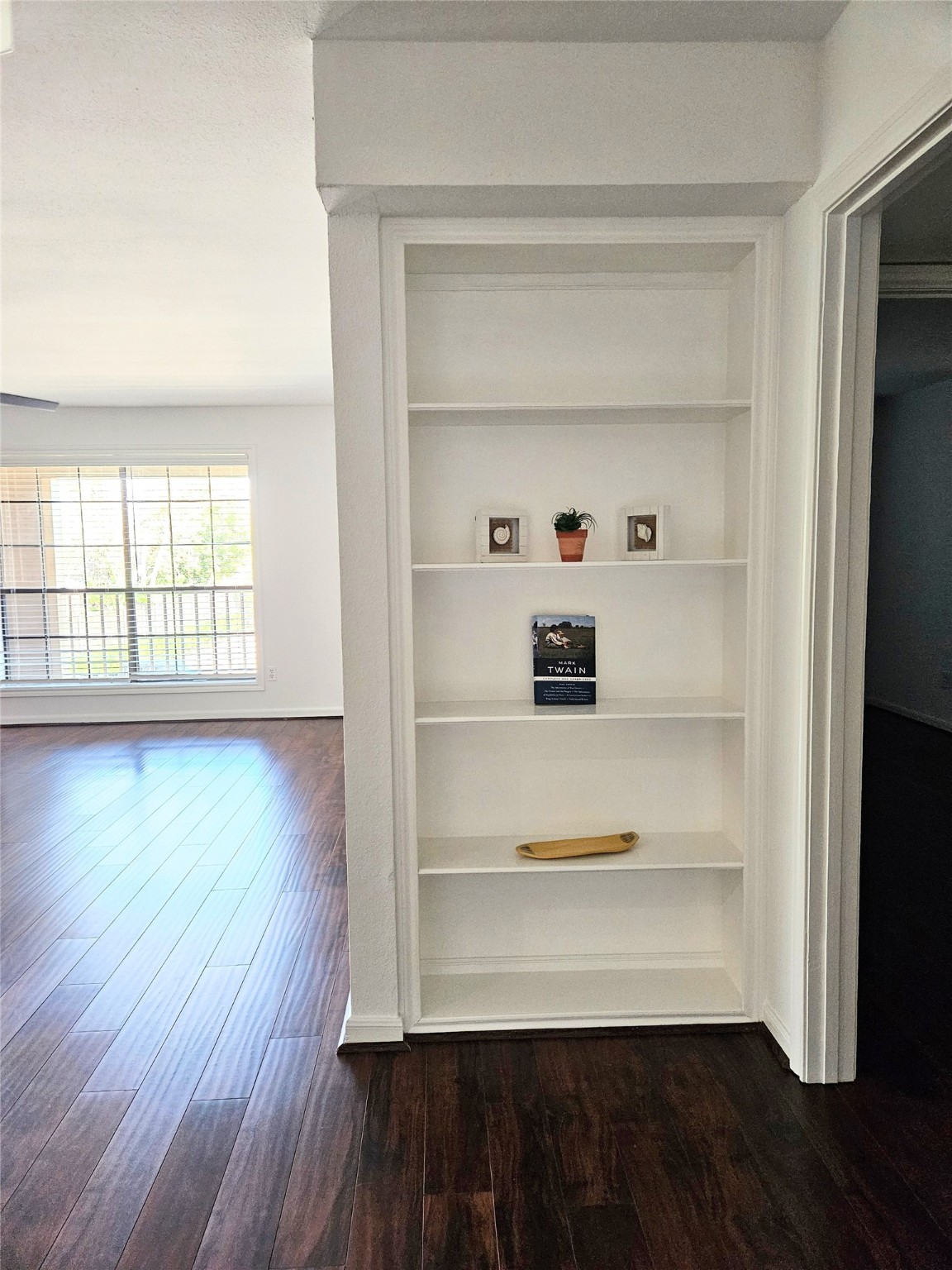 1311 Antoine Drive, Unit 252 Houston, TX 77055 - Photo 11 of 22 a view of an empty room with wooden floor and a window