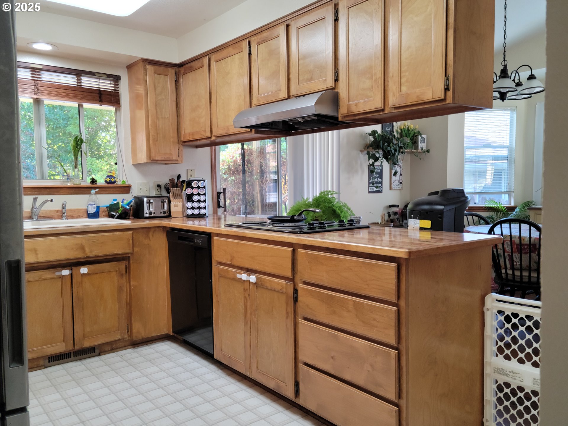 1523 Northwest Thompson Way Grants Pass, OR 97526 - Photo 15 of 39 a kitchen with stainless steel appliances granite countertop a sink a stove window and cabinets