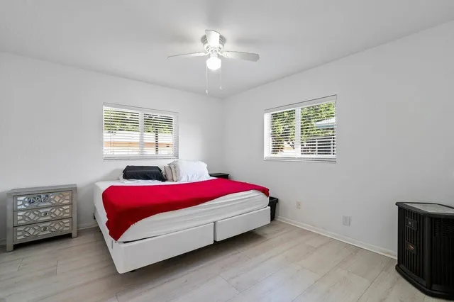 a room with a bed lamp and a window