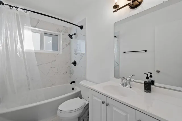 a bathroom with a sink a toilet and a tub