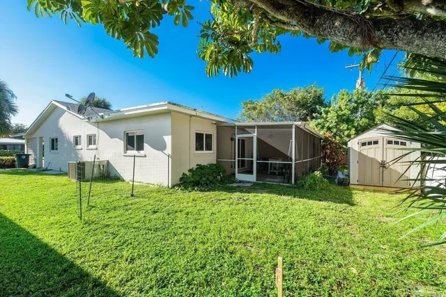 a view of backyard of house with green space