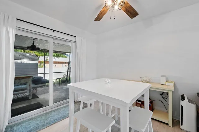a view of a dining room that has a table and chairs