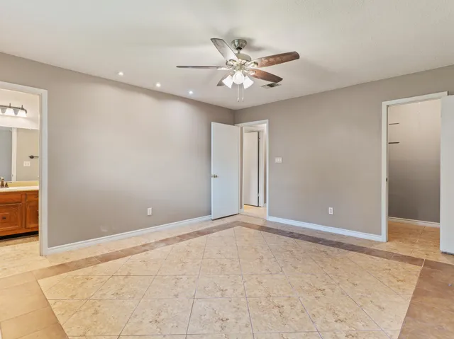 a view of an empty room with a fan